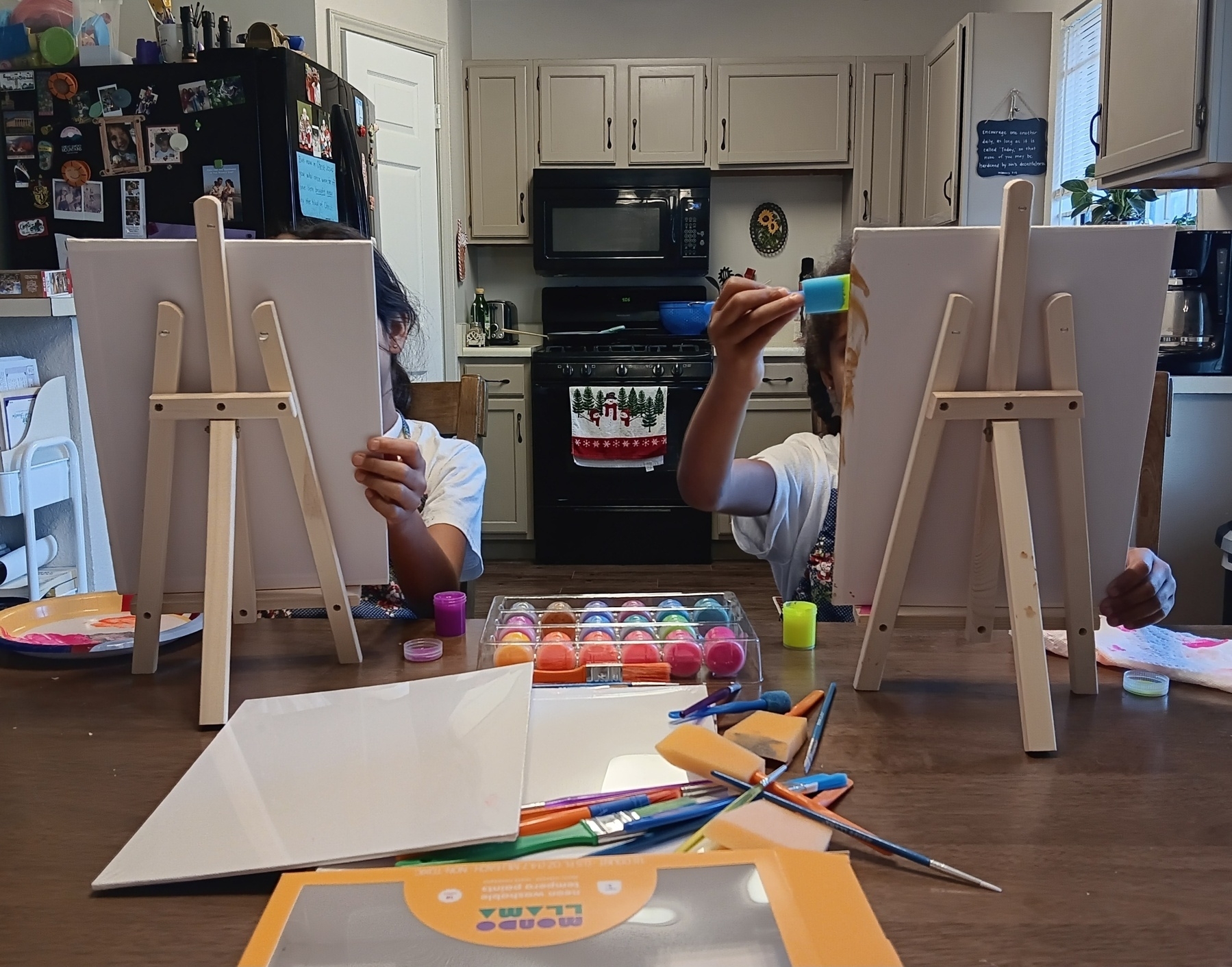 Kids painting at the kitchen table.