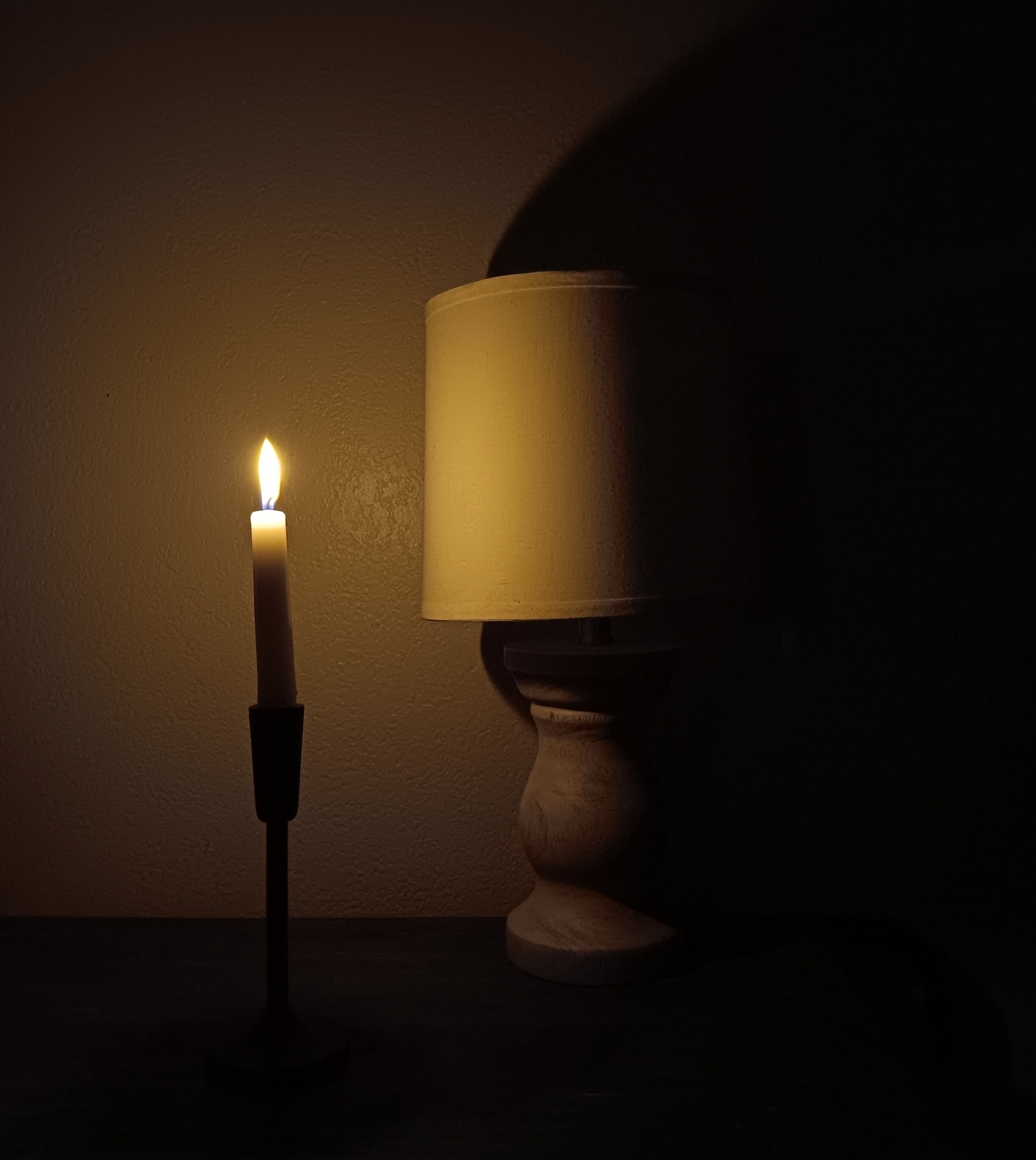 Candle next to a lamp